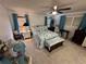 Main bedroom with ceiling fan and light teal bedding at 3301 Alt 19 Lot 819, Palm Harbor, FL 34683