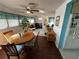 Bright dining room with a wooden table and chairs, view to living room at 3301 Alt 19 Lot 819, Palm Harbor, FL 34683