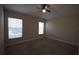 Well-lit bedroom with two windows and ceiling fan at 4311 Rustic Pine Pl, Wesley Chapel, FL 33544