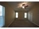 Bedroom with two windows, ceiling fan and sliding glass doors at 4311 Rustic Pine Pl, Wesley Chapel, FL 33544