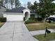 Single-story house with a garage and front yard at 4311 Rustic Pine Pl, Wesley Chapel, FL 33544