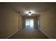 Living room with ceiling fan and access to backyard patio at 4311 Rustic Pine Pl, Wesley Chapel, FL 33544