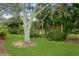 Lush green backyard with mature trees and landscaping at 7313 Emma Rd, Bradenton, FL 34209