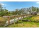 Wooden footbridge over a tranquil waterway at 7313 Emma Rd, Bradenton, FL 34209