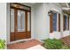 Brown front door with sidelights and a brick walkway at 7313 Emma Rd, Bradenton, FL 34209