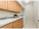 Bright laundry room with washer, dryer, and ample cabinetry at 7313 Emma Rd, Bradenton, FL 34209