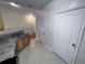 Kitchen area with light wood cabinets and a view into another room at 10412 Villa View Cir, Tampa, FL 33647