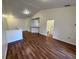 Open living area with wood-look floors and kitchen access at 10412 Villa View Cir, Tampa, FL 33647