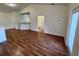 Open living area with wood-look floors and kitchen access at 10412 Villa View Cir, Tampa, FL 33647