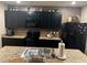 Kitchen with dark cabinets, granite countertops and island at 109 Tierra Verde Way, Bradenton, FL 34212