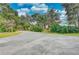 Curved driveway leading to a large white farmhouse at 6936 Handcart Rd, Wesley Chapel, FL 33545