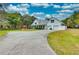 White farmhouse with large driveway, detached garage, and gazebo at 6936 Handcart Rd, Wesley Chapel, FL 33545