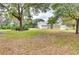 Large grassy yard with mature trees and outbuildings at 6936 Handcart Rd, Wesley Chapel, FL 33545