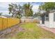 Backyard with a wooden fence and small lawn area at 1502 10Th W St, Bradenton, FL 34205