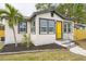 Charming bungalow with a yellow door and well-manicured lawn at 1502 10Th W St, Bradenton, FL 34205