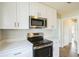 Modern kitchen with stainless steel appliances and white cabinetry at 1502 10Th W St, Bradenton, FL 34205