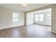 Open concept living room with hardwood floors and ample natural light at 1502 10Th W St, Bradenton, FL 34205