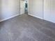 Simple bedroom with grey carpet and double door closet at 1505 Larkin Rd, Spring Hill, FL 34608