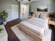 Bright bedroom with light walls, wooden bed frame, and en-suite bathroom access at 1505 Larkin Rd, Spring Hill, FL 34608