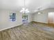 Bright dining room with chandelier and wood-look tile floors at 1505 Larkin Rd, Spring Hill, FL 34608