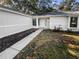 Front exterior view showing walkway and landscaping at 1505 Larkin Rd, Spring Hill, FL 34608