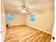 Large bedroom with two windows and wood-look flooring at 2105 Vickery Ln, Dover, FL 33527