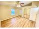 Bedroom with mirrored closet doors and hardwood floors at 2105 Vickery Ln, Dover, FL 33527