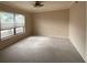 Well-lit bedroom featuring carpet flooring and a window at 37921 Tiffany Rd, Dade City, FL 33525