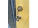 Close up of a yellow door with a key in the lock at 5117 Behms Ct, Port Richey, FL 34668