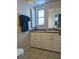 Bathroom with white vanity, drawers, and a window at 2057 Little Neck Rd, Clearwater, FL 33755