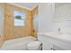 Clean bathroom with a bathtub, toilet and white vanity at 4944 Alseir Rd, North Port, FL 34288