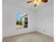 Well-lit bedroom featuring a window overlooking the backyard at 4944 Alseir Rd, North Port, FL 34288
