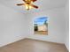 Spacious bedroom with a ceiling fan and large window overlooking the backyard at 4944 Alseir Rd, North Port, FL 34288