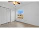 Bright bedroom with large window, double door closet, and tile floor at 4944 Alseir Rd, North Port, FL 34288