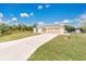 Front view of a house with a long driveway and a fenced backyard at 4944 Alseir Rd, North Port, FL 34288