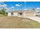 House exterior featuring a beige color scheme and a two-car garage at 4944 Alseir Rd, North Port, FL 34288