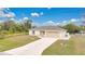 House exterior with a beige color scheme, two-car garage, and flagpole at 4944 Alseir Rd, North Port, FL 34288