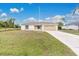 Single-story house with attached garage and a spacious lawn at 4944 Alseir Rd, North Port, FL 34288