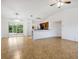Spacious living room with tile floors and kitchen bar at 4944 Alseir Rd, North Port, FL 34288