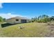 Spacious backyard offering a large grassy area at 7864 Jayman Rd, North Port, FL 34291