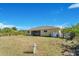 Large backyard with grassy area and screened patio at 7864 Jayman Rd, North Port, FL 34291