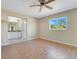 Spacious bedroom with ensuite bathroom access and ceiling fan at 7864 Jayman Rd, North Port, FL 34291