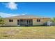 Single-story home with screened lanai and grassy backyard at 7864 Jayman Rd, North Port, FL 34291