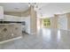 Open kitchen with white cabinets and a breakfast bar at 7864 Jayman Rd, North Port, FL 34291