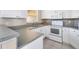 Kitchen with white cabinets, gray countertops and appliances at 7864 Jayman Rd, North Port, FL 34291