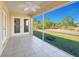 Screened lanai with tiled floor and view of backyard at 7864 Jayman Rd, North Port, FL 34291