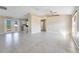 Open living room with tile floors and access to the kitchen at 7864 Jayman Rd, North Port, FL 34291