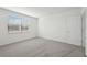 Bright bedroom featuring grey carpet and a window at 14109 Gunnison Cv, Parrish, FL 34219