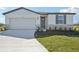 One-story home with gray shutters, stone accents, and a two-car garage at 14109 Gunnison Cv, Parrish, FL 34219