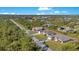 Aerial view of houses on a tree-lined street at 14248 Salvatierra Ln, Port Charlotte, FL 33981